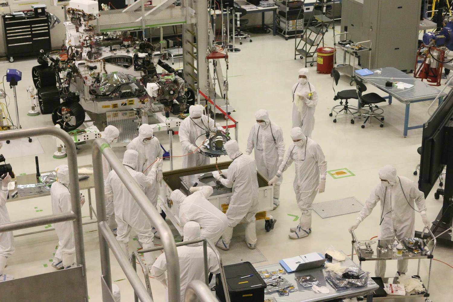 Cleanroom team performing electro-mechanical integration on the assembly floor