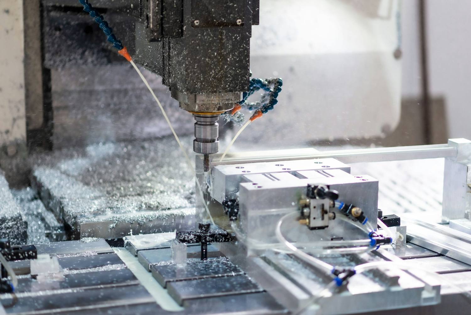 CNC machining centre cutting a precision component under flood coolant